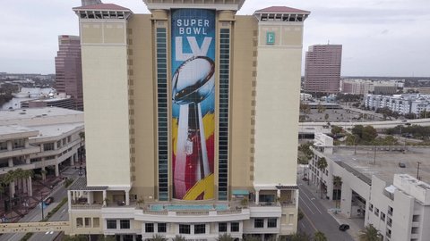 Tampa, Florida  USA - January 17, 2021: Ascending 4K Aerial View of the Embassy Suites by Hilton with the Super Bowl LV Logo and the Vince Lombardi trophy. Revealing downtown in Tampa Florida
