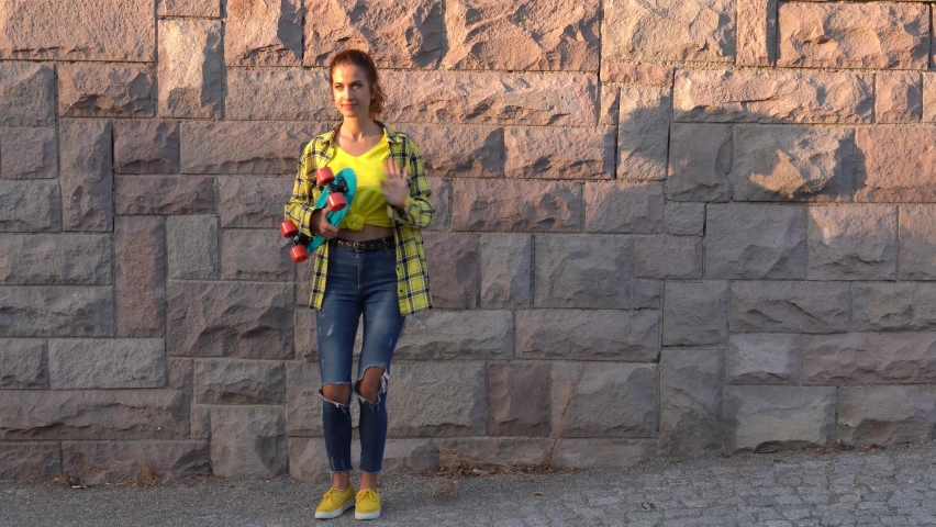 female skateboarder dancing. Female skateboarder skateboarding at skatepark  