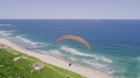 The paraglider flies over the Brazilian coast. 4K