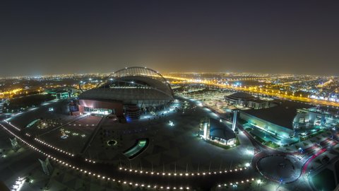 DOHA, QATAR - CIRCA FEB 2019: Aerial view of Aspire Zone from top night to day timelapse in Doha. Traffic on the road. Foggy weather