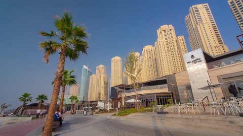 DUBAI, UAE - CIRCA MARCH 2019: Jumeirah Beach Residence Panorama with palms in Dubai timelapse, UAE. Jumeirah Beach is a white sand beach that is located and named after the Jumeirah district of Dubai