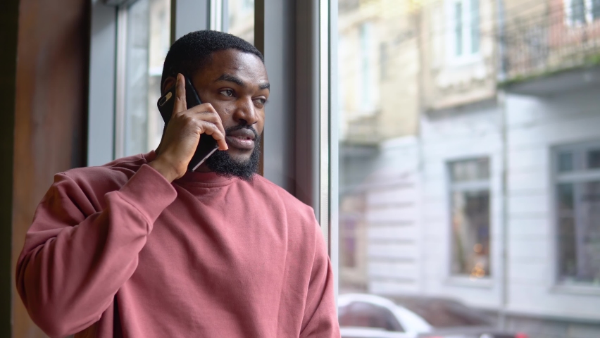 Man having busines conversation by the cellphone in the restaurant