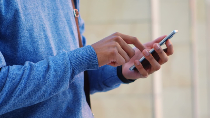 Animation of multiple white spots over midsection of man using smartphone. digital interface global connection and communication concept digitally generated image.