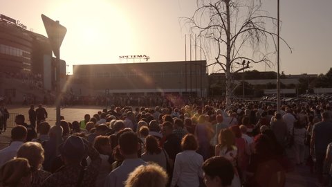Sofia, Bulgaria - 23 May, 2019: Queue of people crowd waiting in line outside Armeec concert hall in Sofia at sunset, slow motion