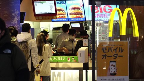 SHIBUYA, TOKYO, JAPAN - 8 JAN 2021 : View of McDonald's fast food store at night. After State of Emergency declaration issued, take out only after 8 p.m to fight the Coronavirus (COVID-19) pandemic.