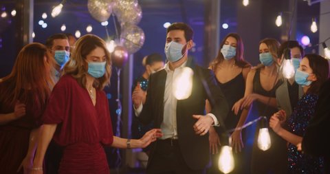 Multi-Ethnic People Company of Happy Coworkers Dancing into Music Celebrating Success Business Victory. Face Masks. SocialDistance. Coronavirus Quarantine.