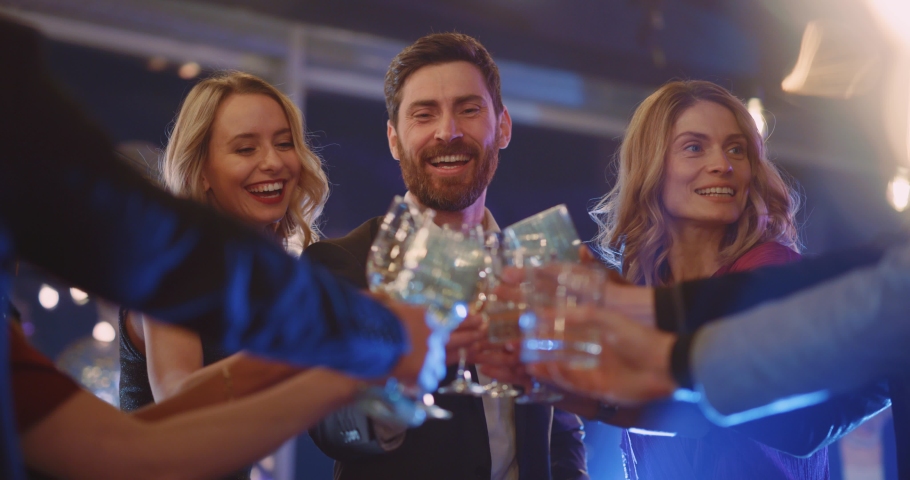 Caucasian handsome happy boss in company of colleagues making festive toast cheering champange drinks together having fun spending corporate party. | Shutterstock HD Video #1065924952