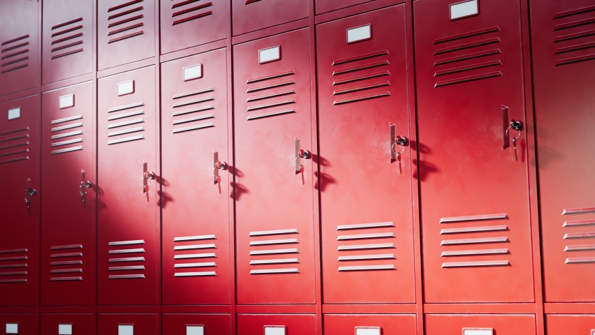 Seamless looping animation of red lockers for students at school or university. An endless row of lockers at college hallway or gym. Safety place for pupils' books or personal things. Keys in locks. Royalty-Free Stock Footage #1065927280