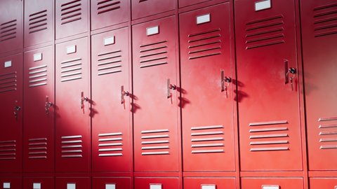 Seamless looping animation of red lockers for students at school or university. An endless row of lockers at college hallway or gym. Safety place for pupils' books or personal things. Keys in locks.