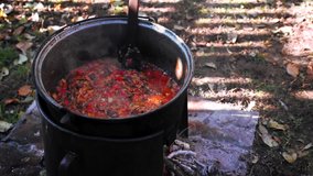 The process of making black bean chili with various vegetables in a pan shot in 4k