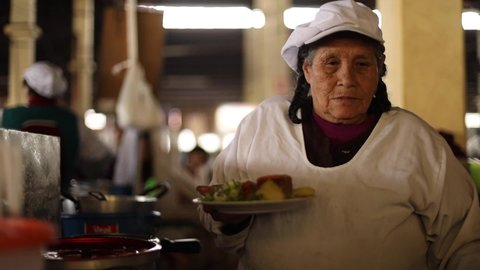 cusco , Peru - 07 09 2020: old women making lunch 