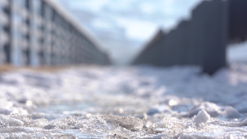  Female legs in black boots on snow, close view. Woman