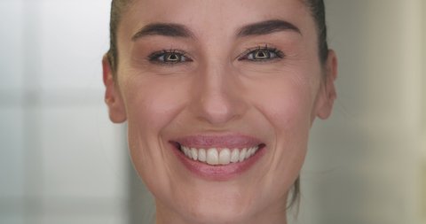 Beauty shot of mature woman face skin with imperfection before and after intensive rejuvenating anti aging treatment smiling in camera isolated on golden fond. Concept: skincare, cosmetics, healthcare