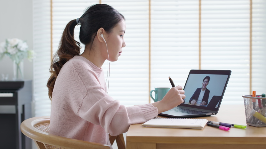 Side view young asian woman listen watch digital class e-learning online for employee reskill upskill on notebook computer at home office workplace. Business school lesson education for adult people. Royalty-Free Stock Footage #1065950869