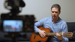 Man with spanish guitar in front of the video camera.