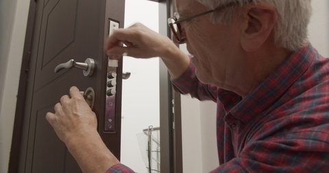 Senior workman repairing the door