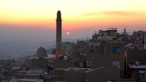 Mardin, Turkey - January 2020: Old city of Mardin cityscape with minaret of Great mosque of Mardin during sunset