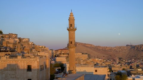 Mardin, Turkey - January 2020: Sehidiye mosque and its minaret with old Mardin cityscape