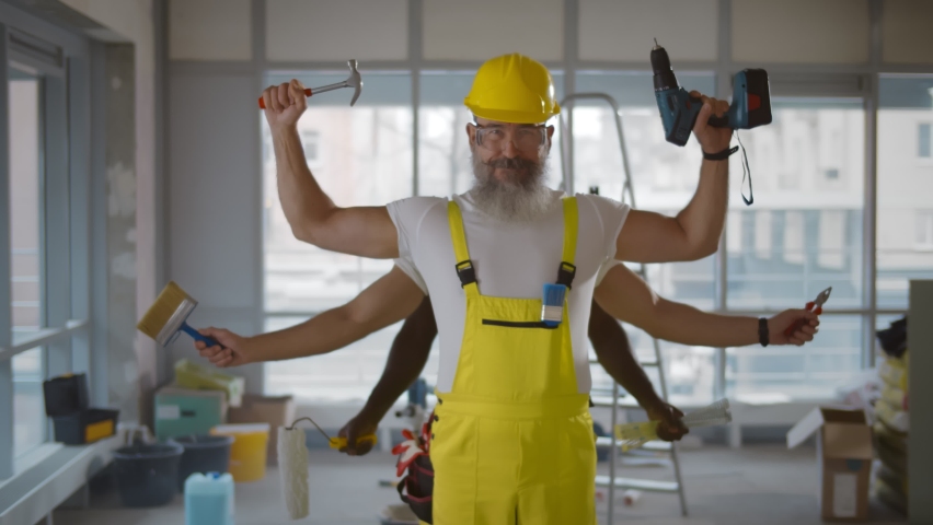 Senior multi-armed builder in overall and hardhat doing renovation. Funny portrait of aged bearded construction worker with many arms holding tools and smiling