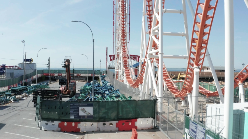 Aerial View of Rollercoaster of Amusement Park in Coney Island, New York. Deserted Location With Overview of Beach and Boardwalk During Covid-19 Virus Outbreak