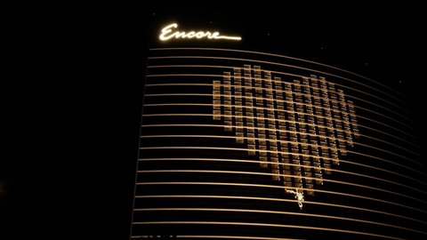 Las Vegas , Nevada , United States - 05 05 2020: Closed Wynn Encore Hotel Casino and Police Car With Rotation Lights, Heart Symbol on Building During Covid Virus Outbreak and Lockdown