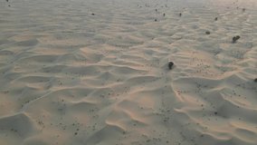 An Aerial footage from a drone for the desert of Dubai UAE at sunset time 