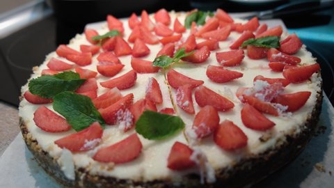 Close-up of fresh homemade cheesecake New York with strawberries and mint, 4k