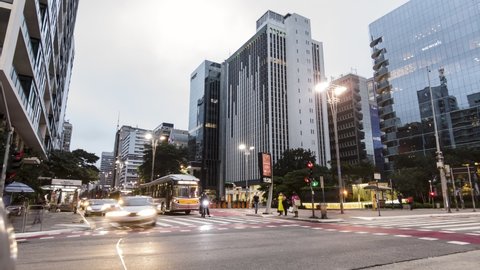 Sao Paulo, Brazil, January 20, 2021. Evening time lapse of movement of people, and vehicles at the corner of Consolacao Street and Paulista Avenue, downtown Sao Paulo.