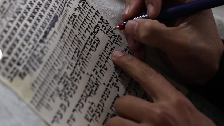 A writer decorates letters in Hebrew, the font of a Torah scroll. The letters were written randomly for training purposes and have no meaning Royalty-Free Stock Footage #1065989701