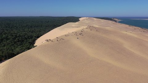 Cap Ferret , France - 07 13 2020: People walk on top of Dune du Pilat in the Arcachon Bassin with a height of over 100 meters