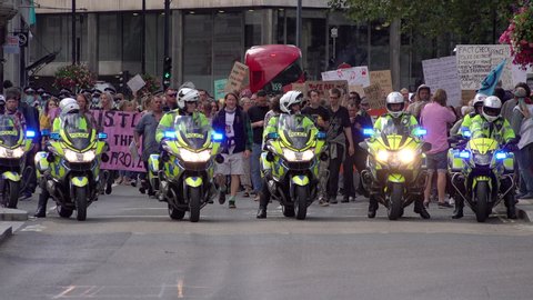 London , United Kingdom (UK) - 09 05 2020: London Metropolitan police officers on motorcycle lead a large protest