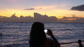 Taking picture of sunset over the ocean in Hawaii in 4k slow motion 60fps
