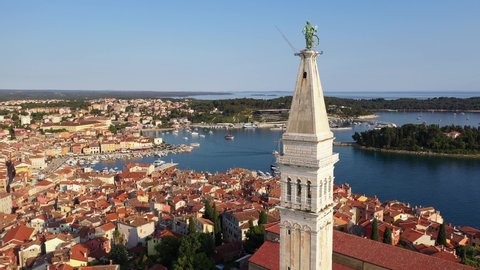 Aerial drone footage of the famous Rovinj medieval old town with its Venetian architecture in the Istria region of Croatia. Shot with an upward and tilt down motion