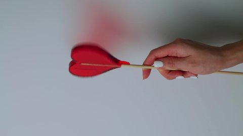Red lollipop in the hands of a girl on a white background. Valentine's day concept. Mother's Day. women's day