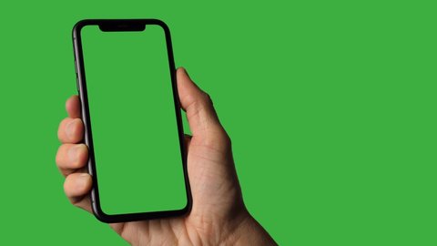 Italy - 2021: Single Tapping and Holding a Green Screen Smartphone
