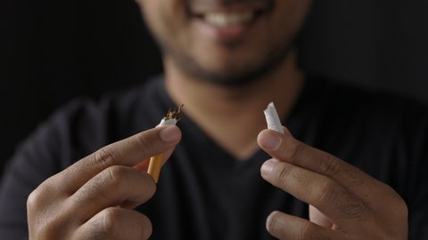 World No Tobacco Day. The young man quit smoking for his good health. He broke a cigarette in two