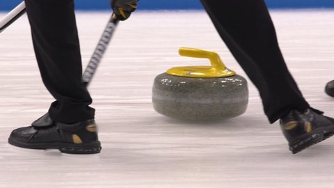 Curling. Winter sport. Curling stones. Ice curling players.