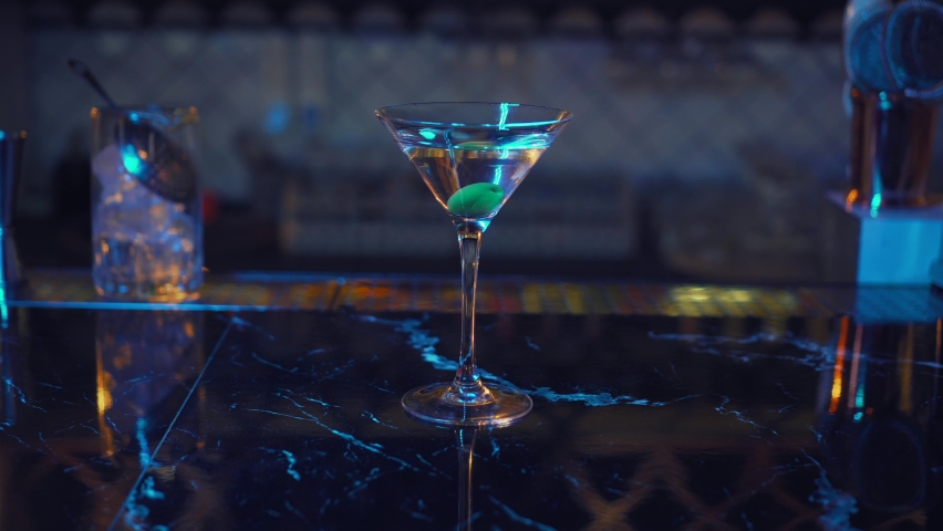 Cooling tonik drink rotating in bar. Alcoholic cocktail