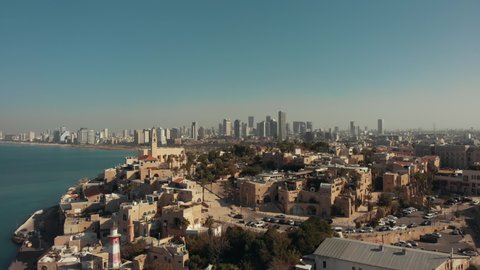 Tel Aviv - Jaffa, view from above. Modern city with skyscrapers and the old city. Bird's-eye view. Israel, the Middle East. Aerial photography. Sea, skyline and blue cloudless sky.