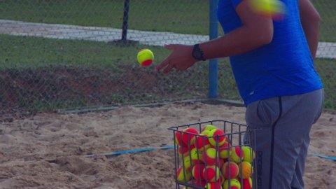 Brasilia , Brazil - 10 01 2020: Brasilia, Brazil - October 2020: man hitting balls over the net for Beach Tennis practice