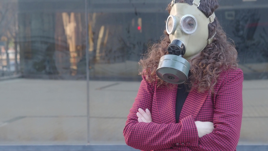 Woman with gas mask in a city. Nuclear apocalypse