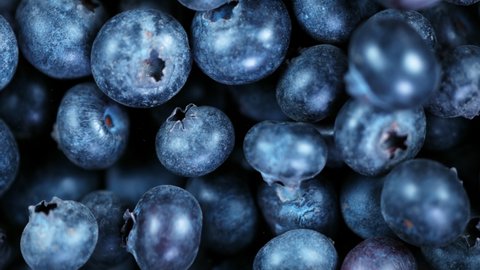 Super Slow Motion Shot of Flying and Rotating Fresh Blueberries at 1000fps.