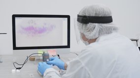 Female senior microbiologist adjusting a digital microscope to analyze a tissue sample. Scientist working at a Microbiology Laboratory. - Powered by Shutterstock - Get 15% off with code: PIKWIZARD15
