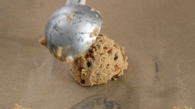 Beautiful female hands spread the cookie dough on a baking sheet. Woman making and Mixing Chocolate Chip Cookies dough in 4K. Concept of Preparing Chocolate Chip cookies step by step. - Powered by Shutterstock - Get 15% off with code: PIKWIZARD15