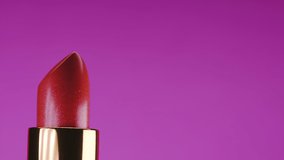 Lipstick opening from container on pink background. Showcase or advertisement for beauty brand, Concept of fashion, cosmetics with copy space
