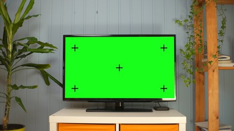 TV with green screen composited. TV or television - green screen - room - on the table. LCD TV with track green screen in modern livingroom