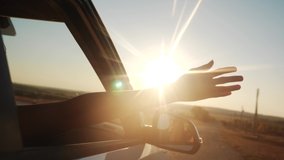 free girl hand out of the window rides a car wind in the face. concept car travel on the road. girl stretches her hand out of the car window sun glare sunset. movement driver hand out of the window - Powered by Shutterstock - Get 15% off with code: PIKWIZARD15