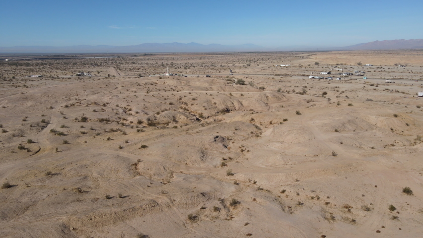 aerial view of Slab City, an unincorporated, off-the-grid squatter community consisting largely of snowbirds in the Salton Trough area of the Sonoran Desert, California, USA. January 16th, 2020 Royalty-Free Stock Footage #1066042924