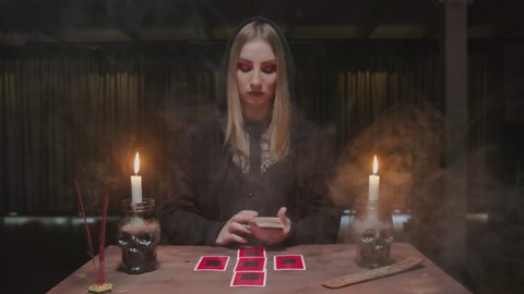 Fortune teller tarot reader placing cards in order as mystic rite.