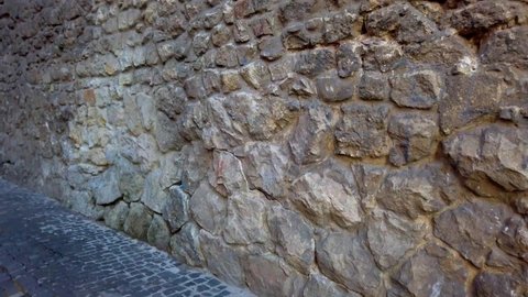 Ancient stone medieval wall. An element of ancient architecture.